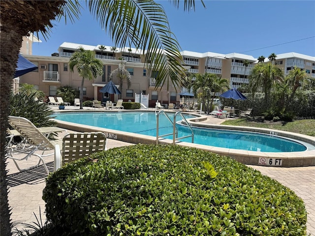 community pool featuring a patio area