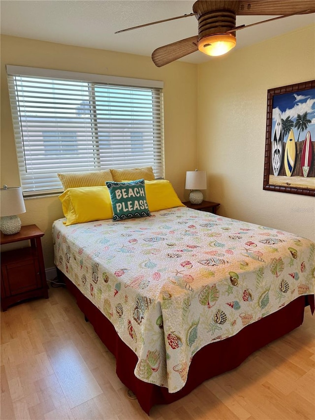 bedroom with ceiling fan and wood finished floors