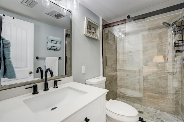 full bathroom featuring toilet, a shower stall, and vanity