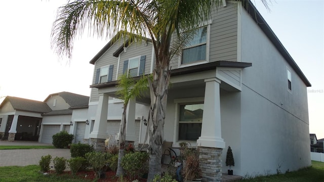 11704 Navajo Sandstone St, Riverview, FL 33579 - view of front of property featuring an attached garage, stucco siding, stone siding, and driveway