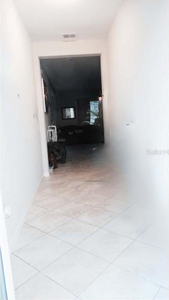 11704 Navajo Sandstone St, Riverview, FL 33579 - hallway featuring light tile patterned floors