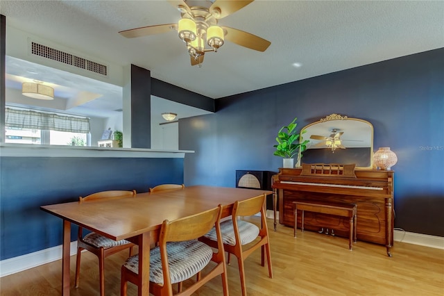 dining area with ceiling fan, wood finished floors, and baseboards