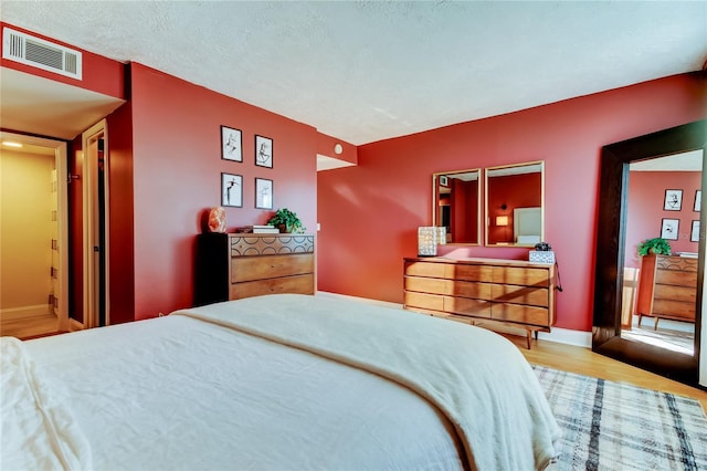 bedroom with wood finished floors and baseboards