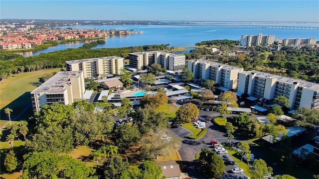 bird's eye view of apartment complex and a large body of water