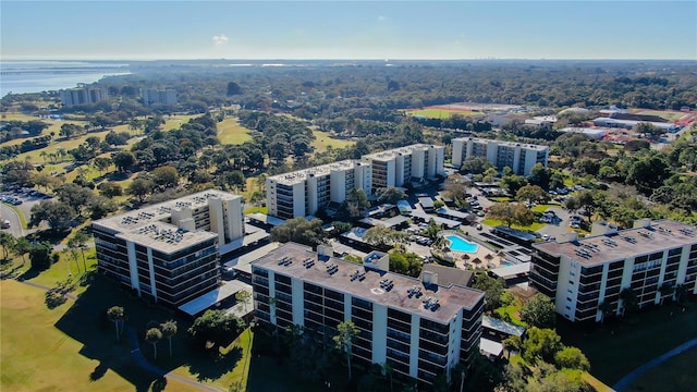 view of urban area with a pool and apartment complex / building