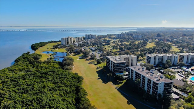 drone / aerial view of a nearby body of water and apartment complex / building