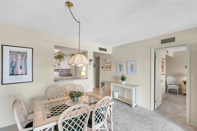 4900 Brittany Dr S Unit 805, Saint Petersburg, FL 33715 - dining space featuring light colored carpet and a textured ceiling