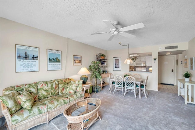 4900 Brittany Dr S Unit 805, Saint Petersburg, FL 33715 - carpeted living room with ceiling fan and a textured ceiling