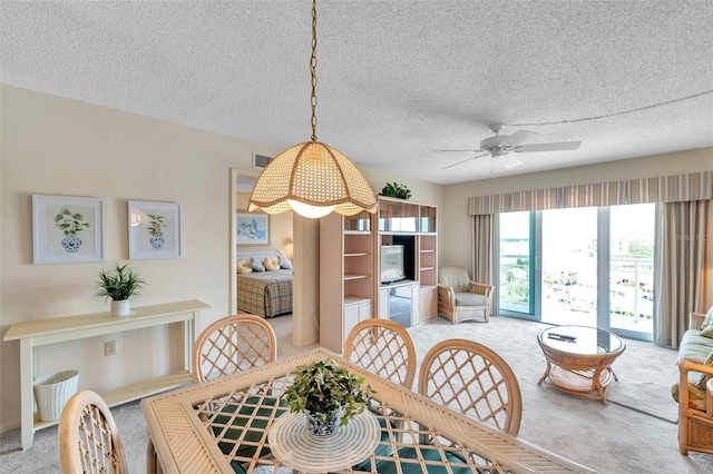 4900 Brittany Dr S Unit 805, Saint Petersburg, FL 33715 - dining area featuring light carpet, a ceiling fan, and a textured ceiling