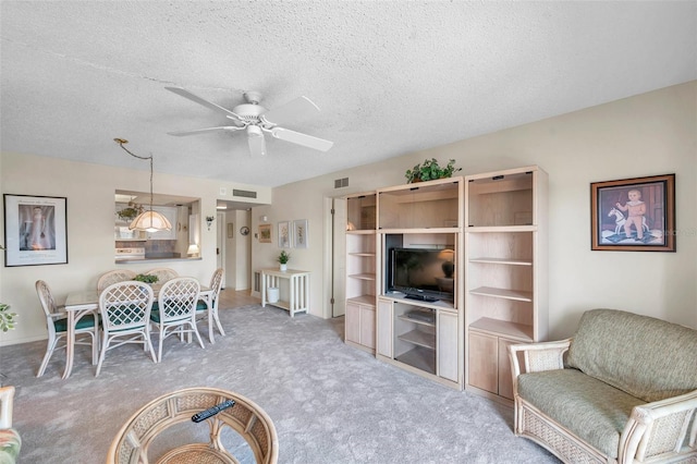 4900 Brittany Dr S Unit 805, Saint Petersburg, FL 33715 - carpeted living room with a ceiling fan and a textured ceiling