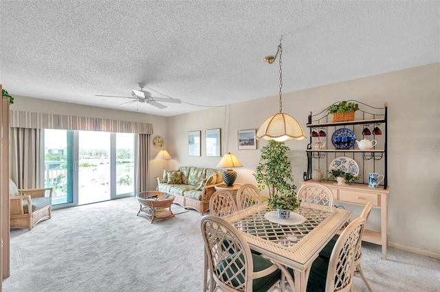 4900 Brittany Dr S Unit 805, Saint Petersburg, FL 33715 - dining space with light carpet, ceiling fan, and a textured ceiling