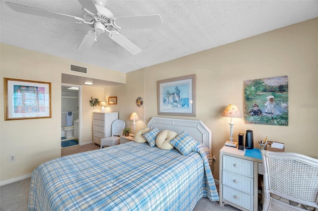 4900 Brittany Dr S Unit 805, Saint Petersburg, FL 33715 - bedroom featuring light carpet, a textured ceiling, baseboards, connected bathroom, and a ceiling fan