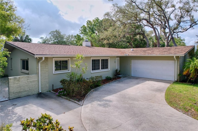 232 Pinecrest Dr, Palm Harbor, FL 34683 - ranch-style home with a garage, a chimney, stone siding, concrete driveway, and stucco siding