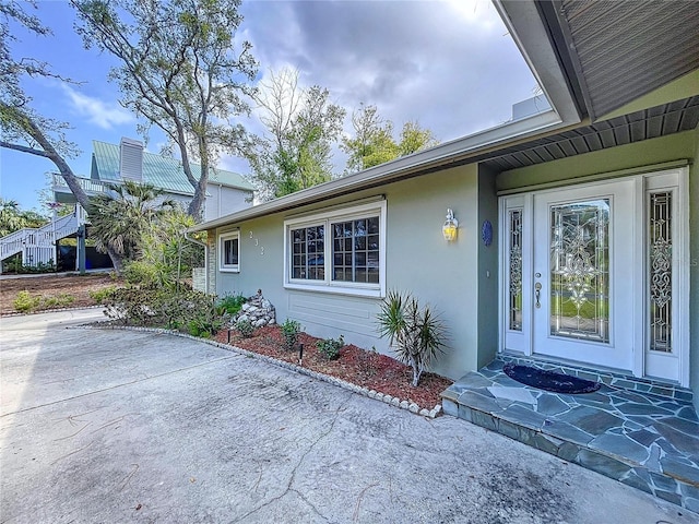 232 Pinecrest Dr, Palm Harbor, FL 34683 - entrance to property featuring stucco siding