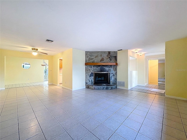 232 Pinecrest Dr, Palm Harbor, FL 34683 - unfurnished living room featuring tile patterned flooring, a stone fireplace, and ceiling fan