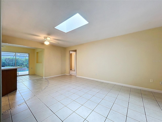 232 Pinecrest Dr, Palm Harbor, FL 34683 - unfurnished room with light tile patterned floors, a skylight, and ceiling fan
