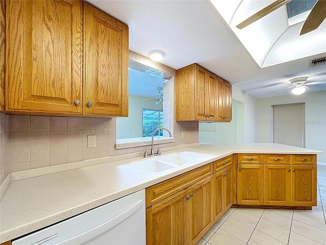 232 Pinecrest Dr, Palm Harbor, FL 34683 - kitchen featuring dishwasher, a ceiling fan, light tile patterned floors, light countertops, and brown cabinetry