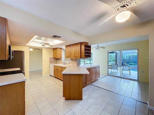 232 Pinecrest Dr, Palm Harbor, FL 34683 - kitchen featuring a ceiling fan, a peninsula, dishwasher, light countertops, and light tile patterned floors