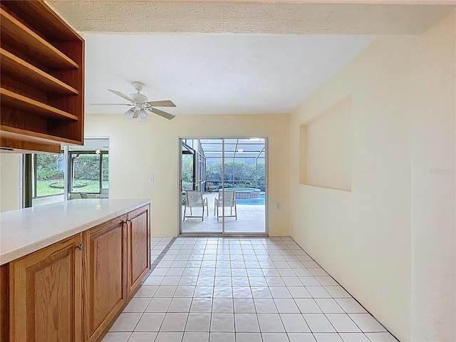 232 Pinecrest Dr, Palm Harbor, FL 34683 - kitchen with light countertops, plenty of natural light, open shelves, and brown cabinets