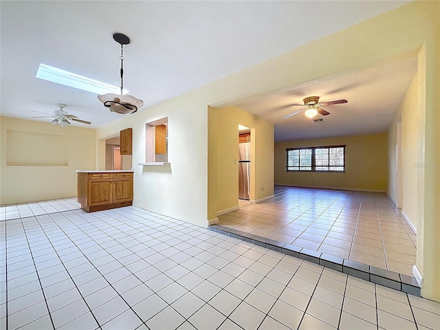 232 Pinecrest Dr, Palm Harbor, FL 34683 - unfurnished living room featuring light tile patterned flooring and ceiling fan