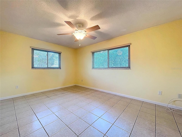 232 Pinecrest Dr, Palm Harbor, FL 34683 - empty room with healthy amount of natural light, light tile patterned flooring, ceiling fan, and a textured ceiling