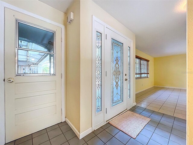 232 Pinecrest Dr, Palm Harbor, FL 34683 - foyer entrance featuring tile patterned floors and baseboards