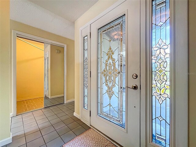232 Pinecrest Dr, Palm Harbor, FL 34683 - entrance foyer featuring tile patterned flooring and a textured ceiling