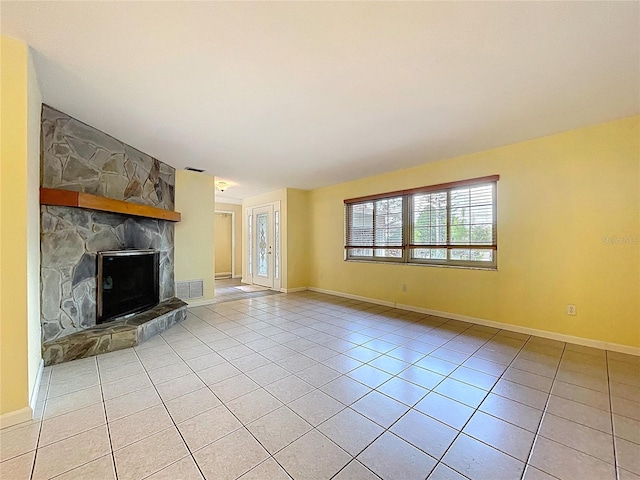 232 Pinecrest Dr, Palm Harbor, FL 34683 - unfurnished living room featuring a fireplace and light tile patterned flooring