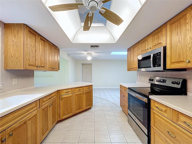 232 Pinecrest Dr, Palm Harbor, FL 34683 - kitchen with stainless steel appliances, a ceiling fan, backsplash, and light tile patterned flooring