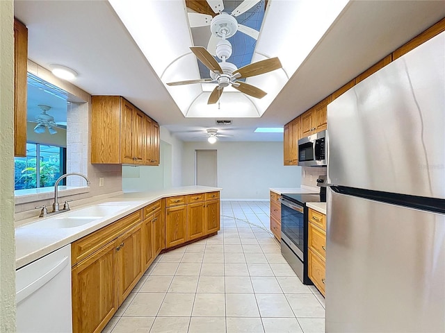 232 Pinecrest Dr, Palm Harbor, FL 34683 - kitchen with appliances with stainless steel finishes, a ceiling fan, light tile patterned floors, and light countertops