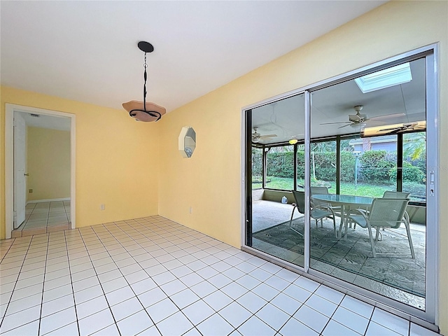 232 Pinecrest Dr, Palm Harbor, FL 34683 - spare room with light tile patterned floors, ceiling fan, and a skylight