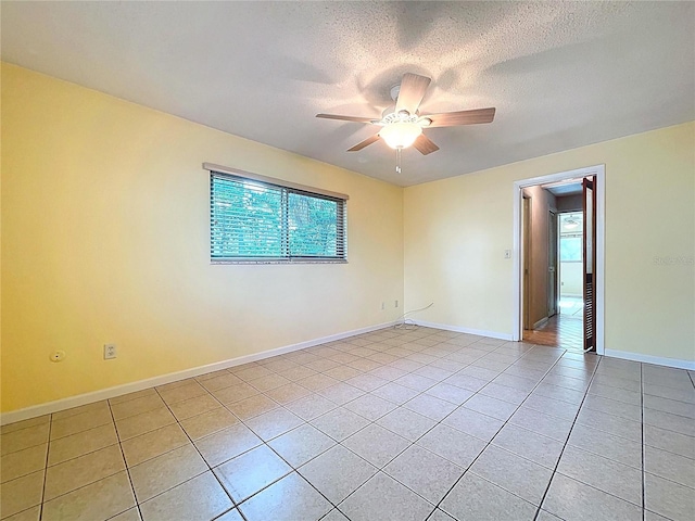 232 Pinecrest Dr, Palm Harbor, FL 34683 - unfurnished room with light tile patterned flooring, plenty of natural light, a ceiling fan, and a textured ceiling