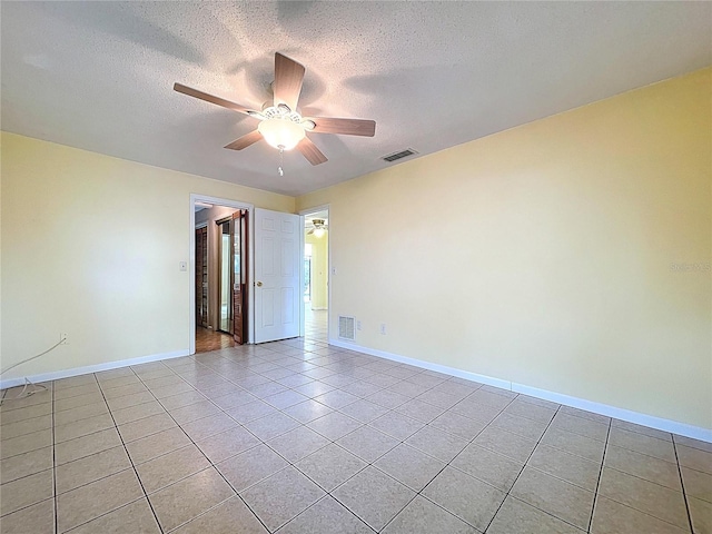 232 Pinecrest Dr, Palm Harbor, FL 34683 - spare room featuring light tile patterned floors, ceiling fan, and a textured ceiling