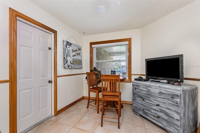 sitting room with light tile patterned floors and baseboards