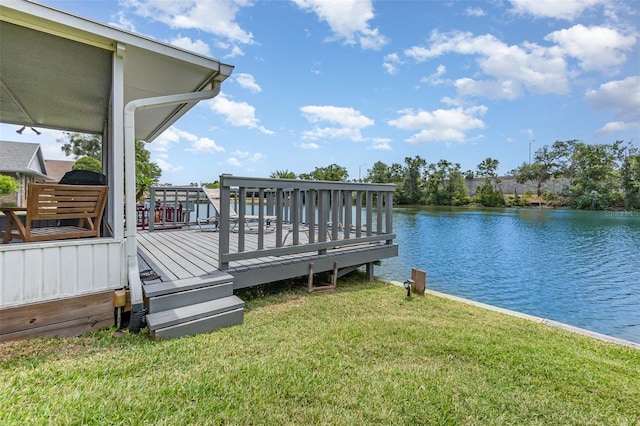 view of dock with a yard and a deck with water view