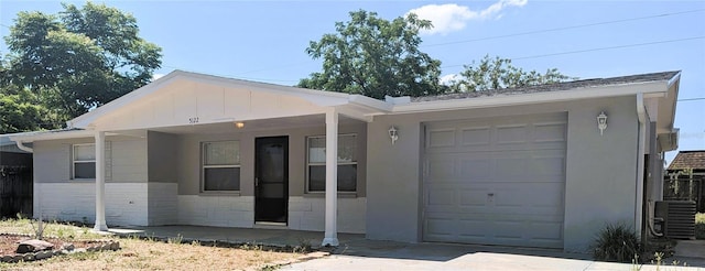 5122 Dove Dr, New Port Richey, FL 34652 - ranch-style home with central AC unit, an attached garage, and driveway