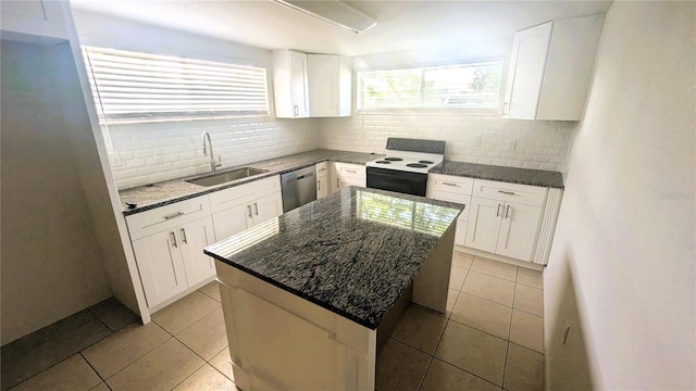 5122 Dove Dr, New Port Richey, FL 34652 - kitchen featuring stainless steel dishwasher, light tile patterned floors, electric range oven, and a sink