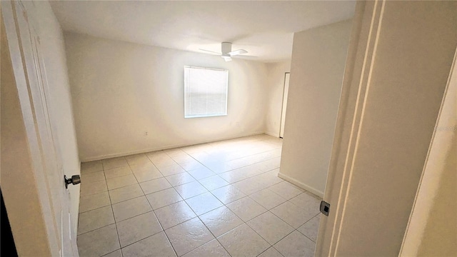 5122 Dove Dr, New Port Richey, FL 34652 - empty room with light tile patterned floors, baseboards, and ceiling fan