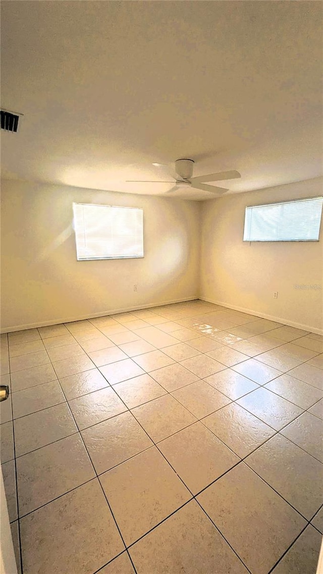 5122 Dove Dr, New Port Richey, FL 34652 - empty room with ceiling fan, baseboards, light tile patterned floors, and visible vents
