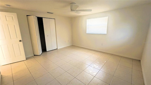 5122 Dove Dr, New Port Richey, FL 34652 - unfurnished bedroom with baseboards, a closet, visible vents, and light tile patterned flooring