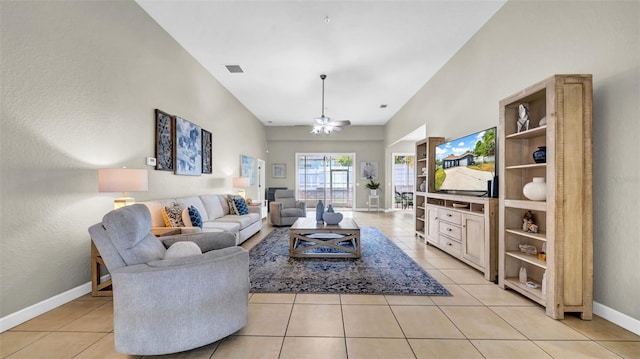 living room featuring light tile patterned floors, baseboards, and high vaulted ceiling
