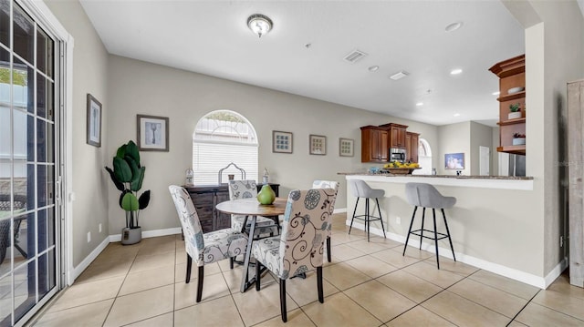 dining room featuring light tile patterned floors, recessed lighting, and baseboards