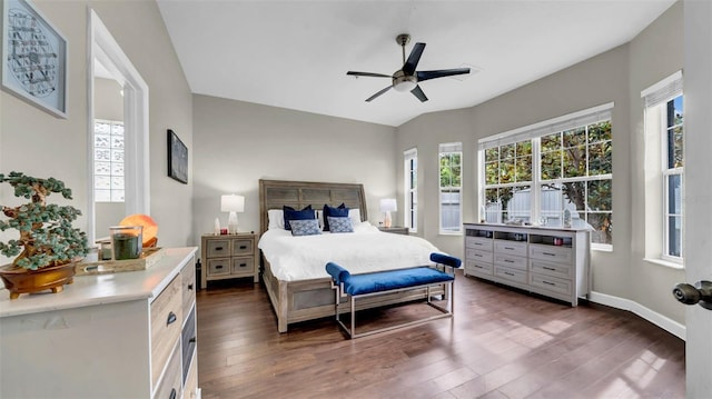 bedroom with dark wood-style flooring, ceiling fan, and baseboards