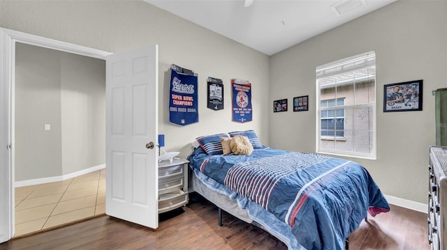 bedroom featuring baseboards and wood finished floors