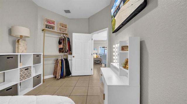 bathroom with tile patterned floors and a textured wall