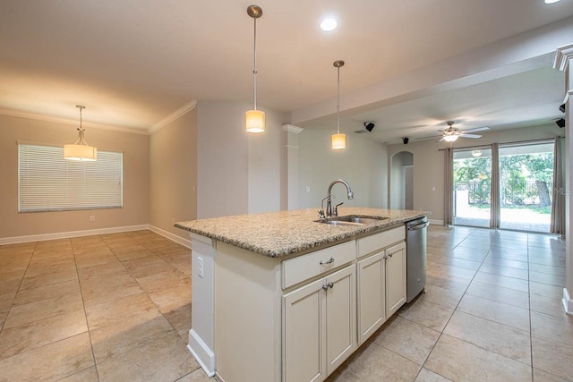 kitchen featuring a sink, dishwasher, arched walkways, a ceiling fan, and baseboards