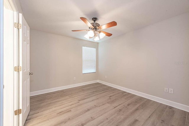 empty room featuring ceiling fan, light wood-style flooring, and baseboards