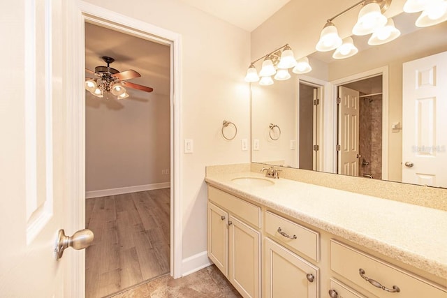 bathroom with vanity, baseboards, ceiling fan, and curtained shower
