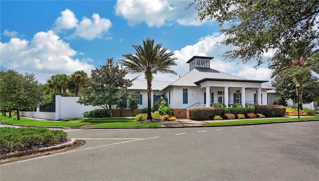 view of property featuring uncovered parking and fence