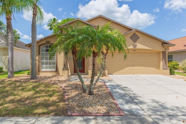 mediterranean / spanish-style house with concrete driveway, stucco siding, and a garage